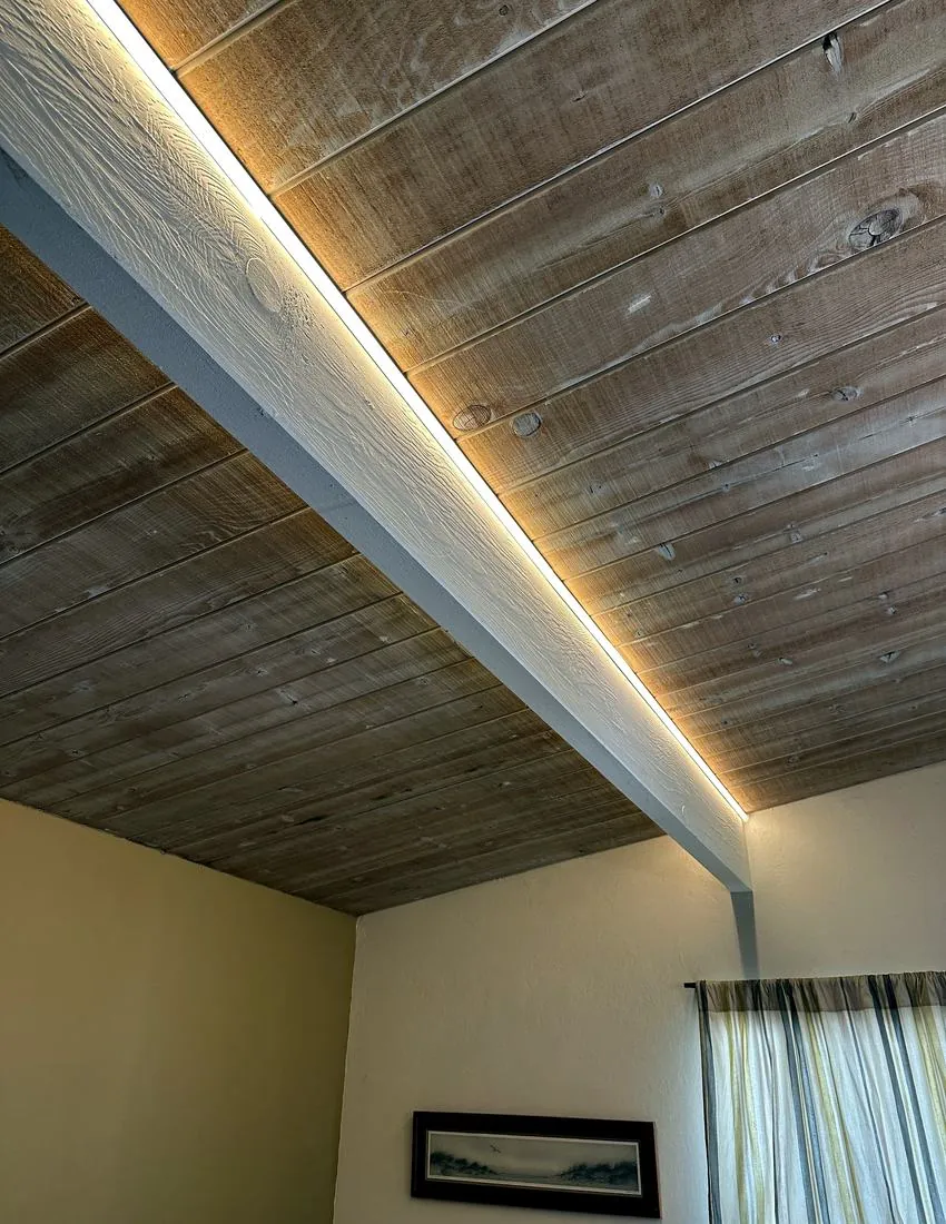 LED accent lighting installed along a vaulted wood ceiling by Spark Electrical Solutions
